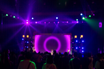 Fototapeta na wymiar Bright colorful stage lights of purple blur background, Bokeh concert light