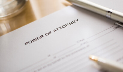 A power of attorney form on the desk. 