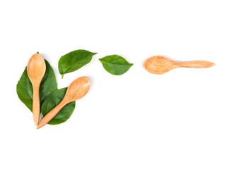 Wooden spoon and green leaves, Natural wooden utensils Eco-friendly And safe for health With copy space for text of design