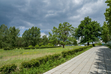 summer, day, walk, rest, promenade, landscape, landscape, nature, urban, embankment, recreation area, path, lawns, grass, trees, vegetation, slope, sky, clouds, bad weather, observation, light, shadow