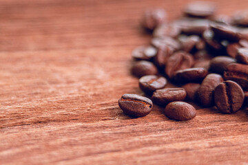 Roasted coffee beans on wood with copy space.