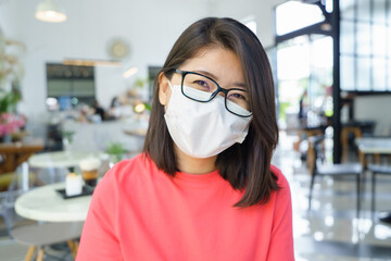 New normal asian beauty Wear a mask to prevent Covid 19 viruses or coronavirus. Scaffolding with Smiling under the mask. Social distancing and and keep distance concept.