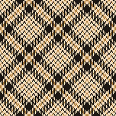 Tweed plaid pattern in gold and black. Seamless diagonal abstract geometric check plaid for coat, skirt, jacket, or other modern autumn fabric design.