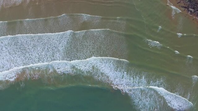 The beautiful pattern of the waves leading into an estuary on the Cantabrian Sea coast can be seen.