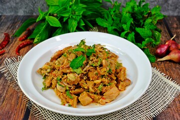 Hot and spicy grilled pork neck salad having key ingredients displayed aside.