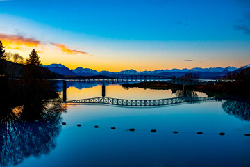 Stunning reflections of the Lake Tekapo footbridge over Scott Pond at sunset