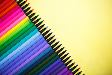 A set of markers with a large number of shades and halftones on a yellow background with space for text.