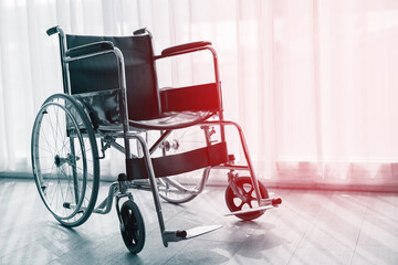 Wheelchair with morning sun by the window background in room hospital. Wheelchairs waiting for patient services. with copy space empty on right area. Black and white picture.