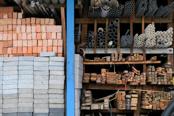 Construction building materials and industrial supplies such as bricks, woods and pipes stacked and...