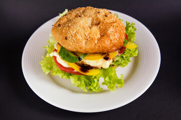 
Burger with beef patty tomato and vegetables with lettuce