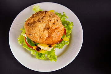 
Burger with beef patty tomato and vegetables with lettuce