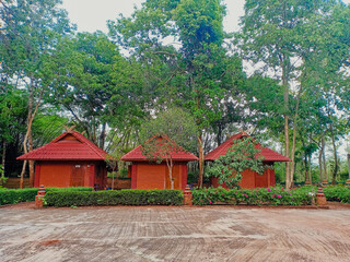 Fototapeta na wymiar Tree red brick earthen house or homestay among the trees. 