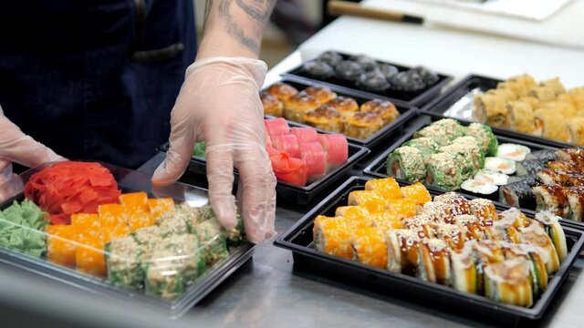 Sushi and rolls set in a plastic box. Delivery service consept
