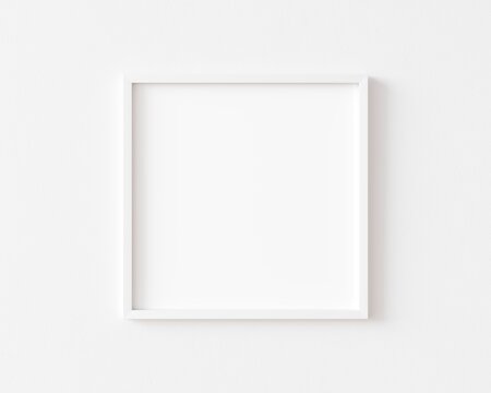 White square photo frame on white wall. 3d illustration.