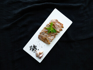 Grilled pork,Ingredients garlic, pepper,Place on a white plate,sprinkle with pepper,Decorate the face with mint leaves,Thai food