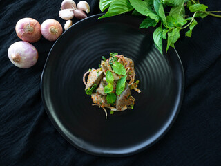 Spicy Pork Liver Salad,Ingredient
Onion,Roasted rice,Basil,Pepper,On a black plate,Thai Street Food