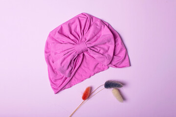 Cute children's headband or turban on pink background.