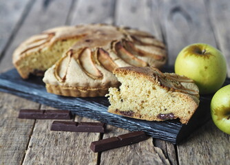 Homemade Apple pie on a rustic wooden background. A classic dessert made of dough for any holiday.