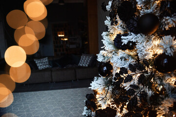 Classic Christmas decorated interior room New year tree. Christmas tree with gold decorations. Modern white classical style interior design apartment with fireplace and armchair.