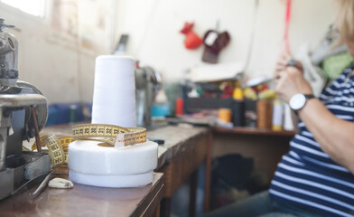 Measuring tape on the table. Seamstress working