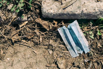 A used medical face mask dumped on the ground during the Covid-19 pandemic.