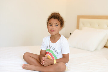 Cute little girl in pajamas on the bed in the morning