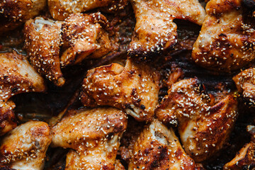 Baked pickled chicken wings. Sprinkled with sesame seeds on top.