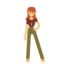 Caucasian young woman in a tshirt and pants stands and smiles.