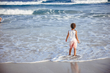 happy  little girl have fun and joy time at beautiful beach