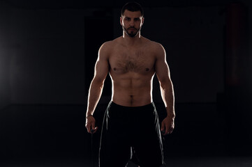 Fototapeta na wymiar boxer on a dark background silhouette before a fight fitness club