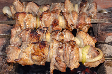 B-B-Q. Skewers on skewers on charcoal grilled close up with, onion. Barbecue. Dinner.