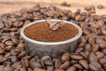 ground coffee on the background of loose coffee beans