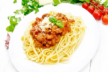 Spaghetti with bolognese on white wooden board