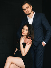 fashionable young married couple posing stylishly. Caucasian man and pregnant woman