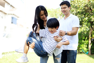 Happiness young family in holiday activities weekend at garden park.