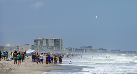 Cocoa Beach, FL, USA - MAY 30, 2020: SpaceX first astronaut launch from NASA. View from Cocoa Beach. People are watching for historic Spacex NASA launch in Florida US. A SpaceX Falcon 9 rocket.