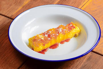 Tasty delicious sweet dessert with honey served on a white plate over dark rustic wooden background.