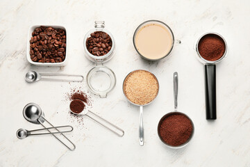 Composition with coffee beans and powder on light background