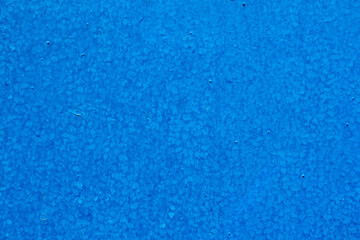 Obraz na płótnie Canvas The texture of blue paint on a metal surface, applied with a brush.