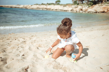 Sand castle and family at sea. Family beach vacation concept.