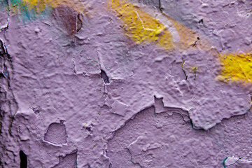 Purple wall with cracked plaster