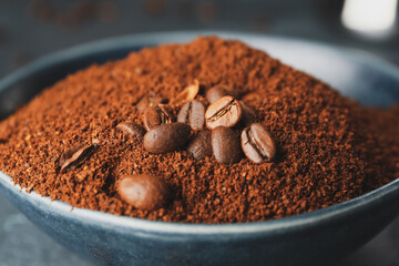 Bowl with coffee powder and beans, closeup