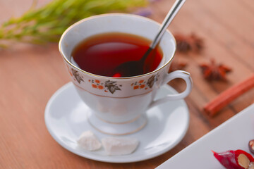 Tasty oriental sweets. Caucasian delicacy churchkhela - georgian nut treats. Served with a glass of tea and a tea pot.
