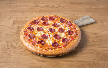 Pepperoni pizza on a wooden table
