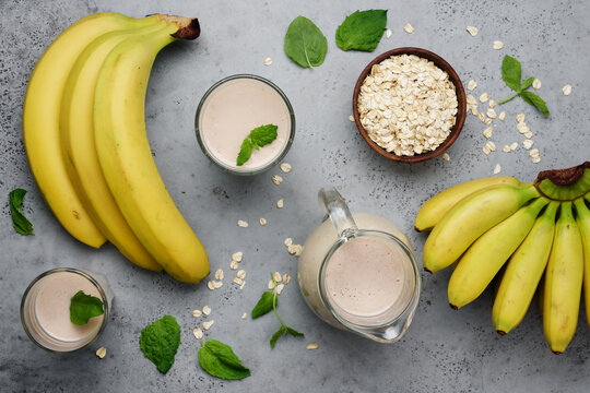 Oatmeal banana smoothie for healthy breakfast. Healthy drink in glasses and  jur