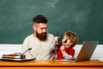 Back to school and Education concept. Teacher helping young boy with lesson. Back to school. Homeschooling. Teacher and child. Young boy doing his school homework with his father