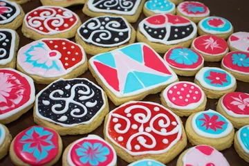 Papier peint photo  Homemade icing cookies with coloured glaze and white topping on  wooden background.  © Елена Пономарева