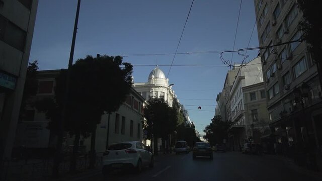 ride with car in Athens city centre busy day traffic buildings around greek architecture urban lifestyle everyday life