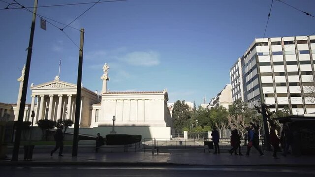 car ride at Athens city centre in Greece , people walking ,light traffic at road greek architecture , heart of city urban lifestyle