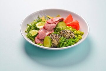 Fresh and organic vegetable salad with raw veggies - tomatoes, cucumbers, avocado. Flat lay, copy space banner.